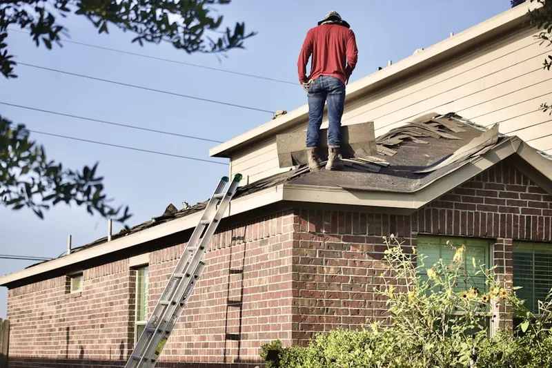 Professional roofer working on a residential roof in Nancys Corner